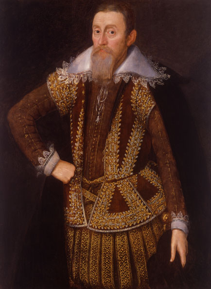 Shows a portrait of a man with a beard dressed in an ornate brown and gold costume with a large white collar. His right hand rests on his hip and his left hand holds a dark hat.