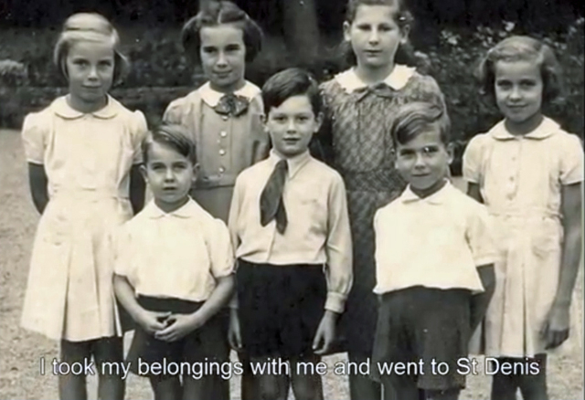 A screenshot showing a black and white photograph of a group of children. 