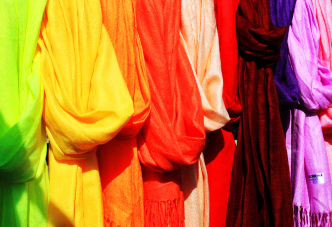 A picture showing brightly coloured scarves. 