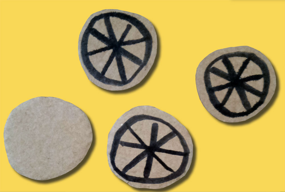 cardboard circles with drawn on simple wheel design