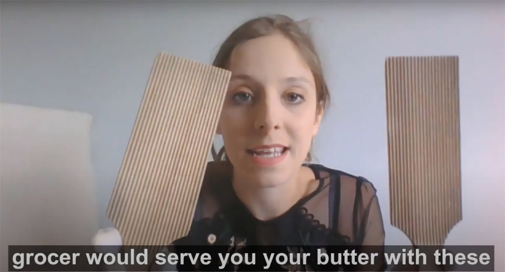 video screenshot of woman holding butter paddles
